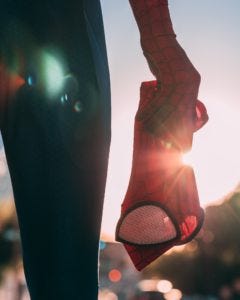 Man holding spiderman mask