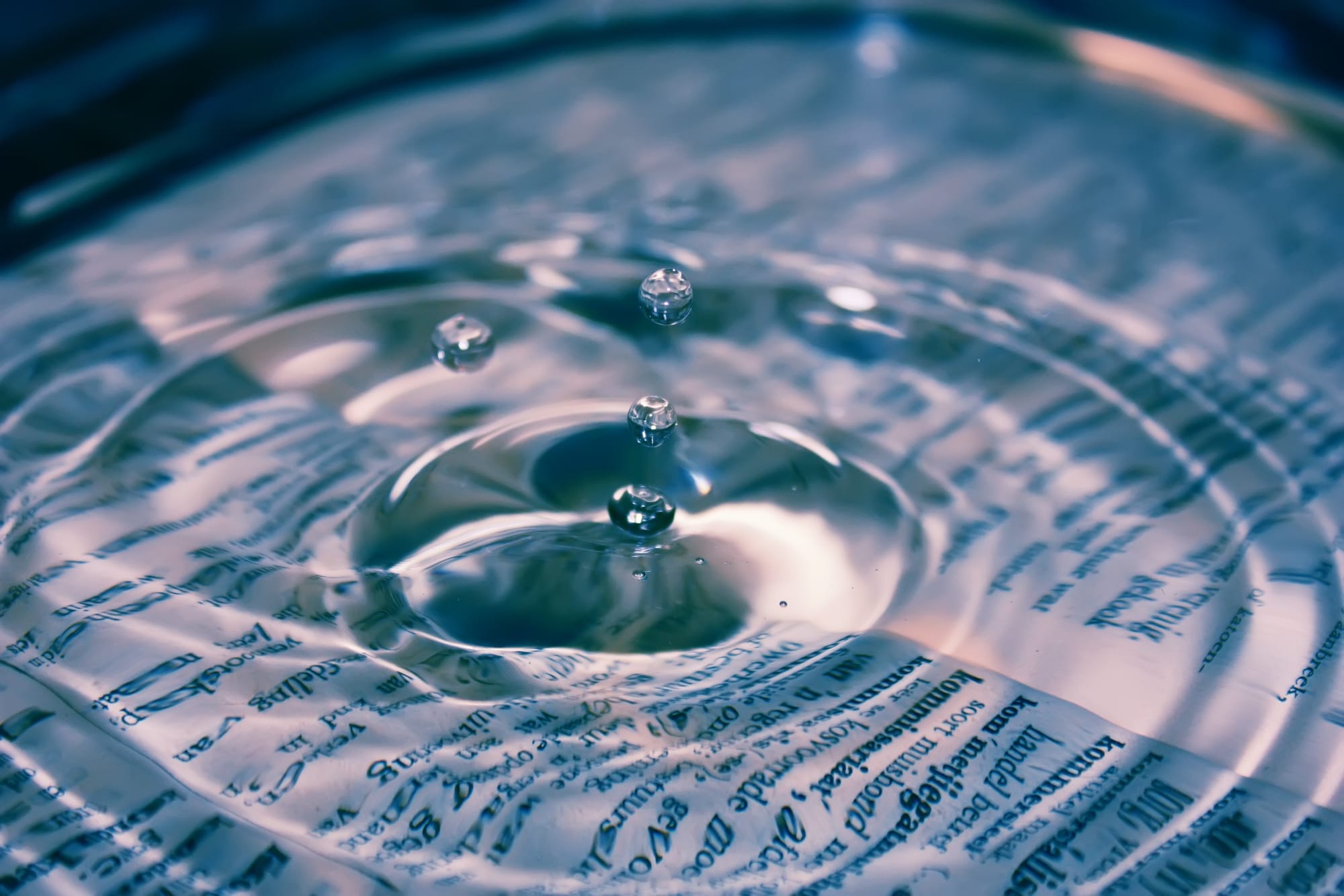 water drop rippliing out on book pages