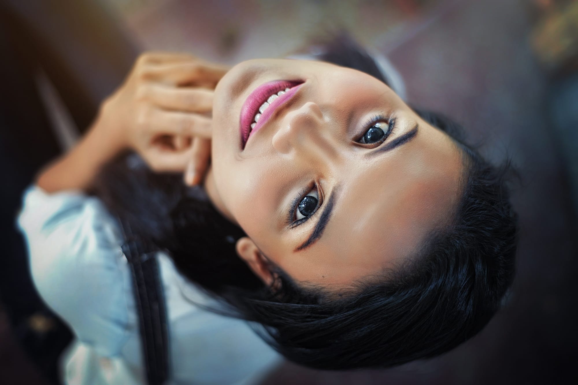 woman smiling with head tilted back